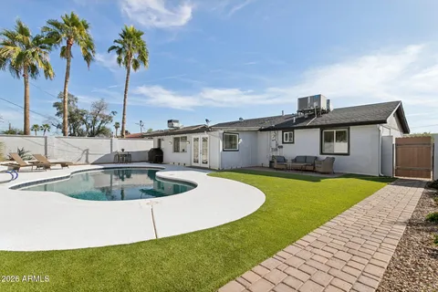 a view of an house with backyard and patio