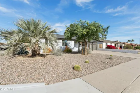 a view of a house with a yard and sitting area