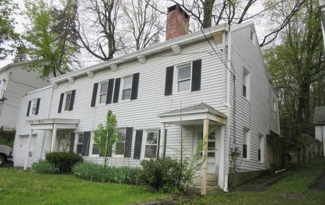 17 Quaker Hill Road Pleasant Valley, NY 12569 - Photo 1 of 1 a view of a white house next to a yard with big trees
