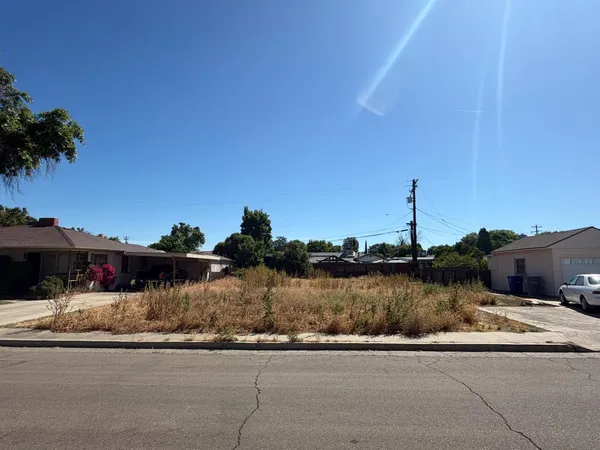 a view of a lake with a house and a big yard