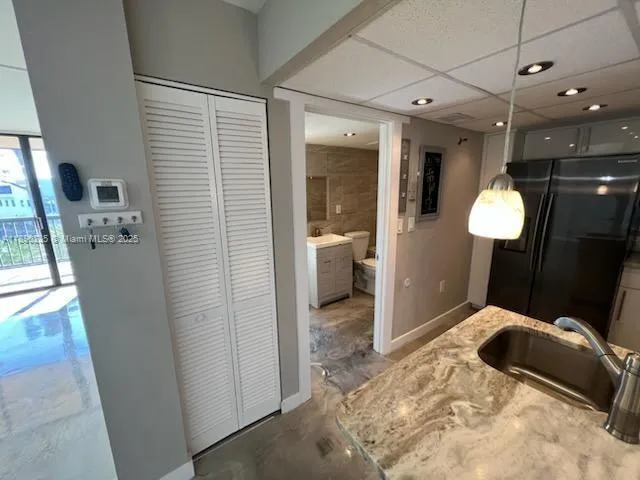 a kitchen with stainless steel appliances granite countertop a refrigerator and a sink