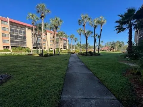 a front view of a house with a yard and lake view