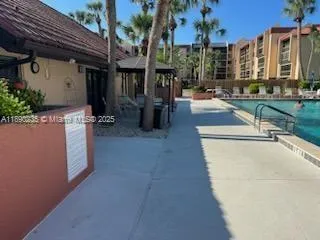 a swimming pool with outdoor seating and yard