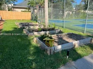 a view of a street with cars parked