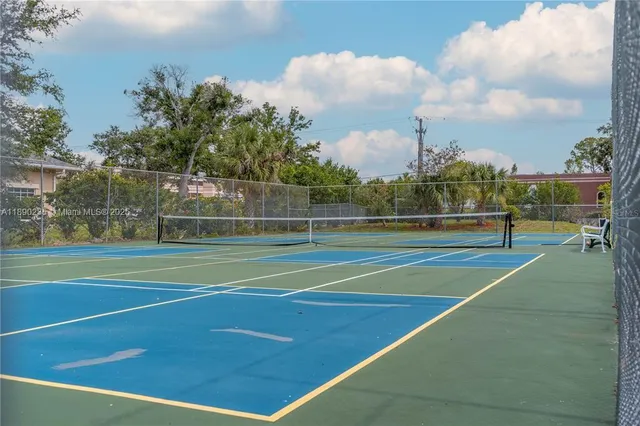 a park with bench and lake view
