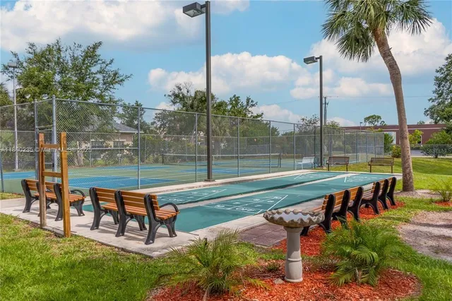 a view of a building with a yard and plants