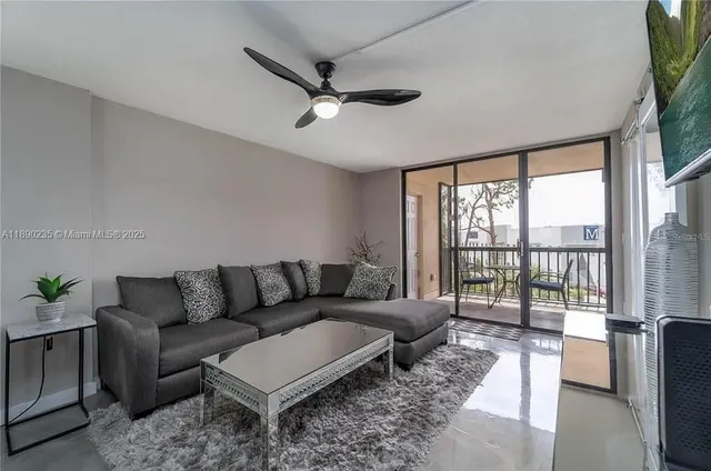 a living room with furniture and a large window