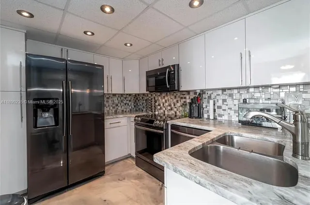 a kitchen with a sink stove and refrigerator