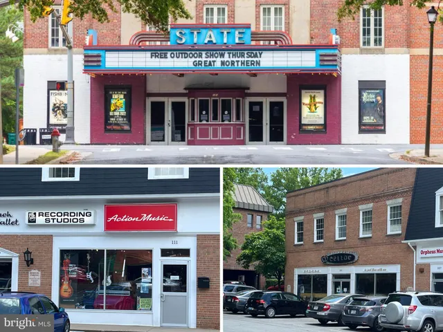 a front view of multi story building with retail shops