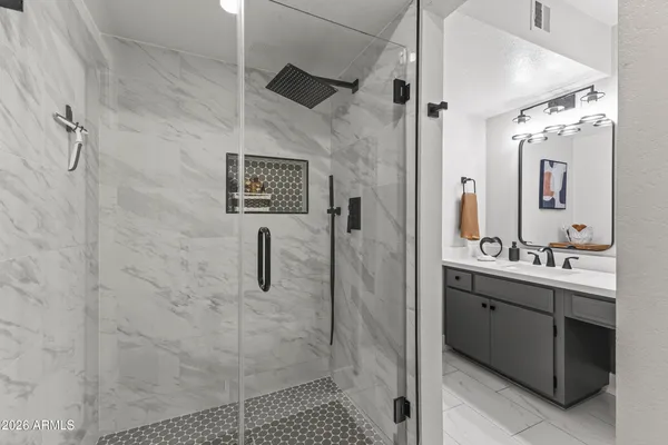 a bathroom with a sink vanity and a mirror