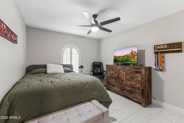 a bedroom with a bed and a television