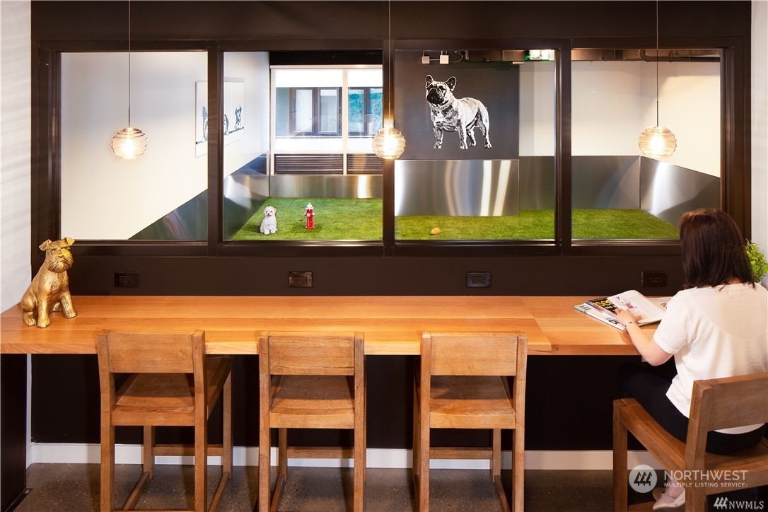 450 South Main Street, Unit 1110 Seattle, WA 98104 - Photo 11 of 24 a view of a dining room with furniture and wooden floor