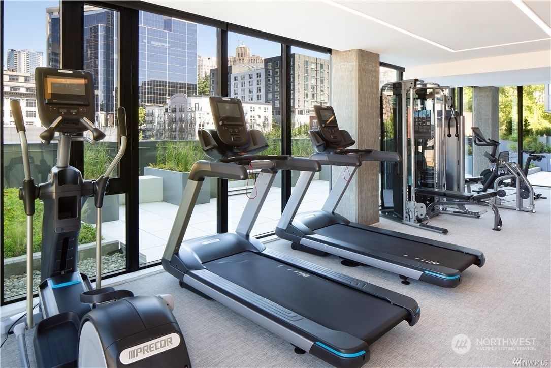 450 South Main Street, Unit 1110 Seattle, WA 98104 - Photo 14 of 24 a room with gym equipment and a large window