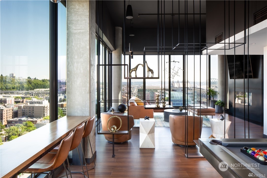 450 South Main Street, Unit 1110 Seattle, WA 98104 - Photo 21 of 24 a living room with furniture floor to ceiling window and wooden floor