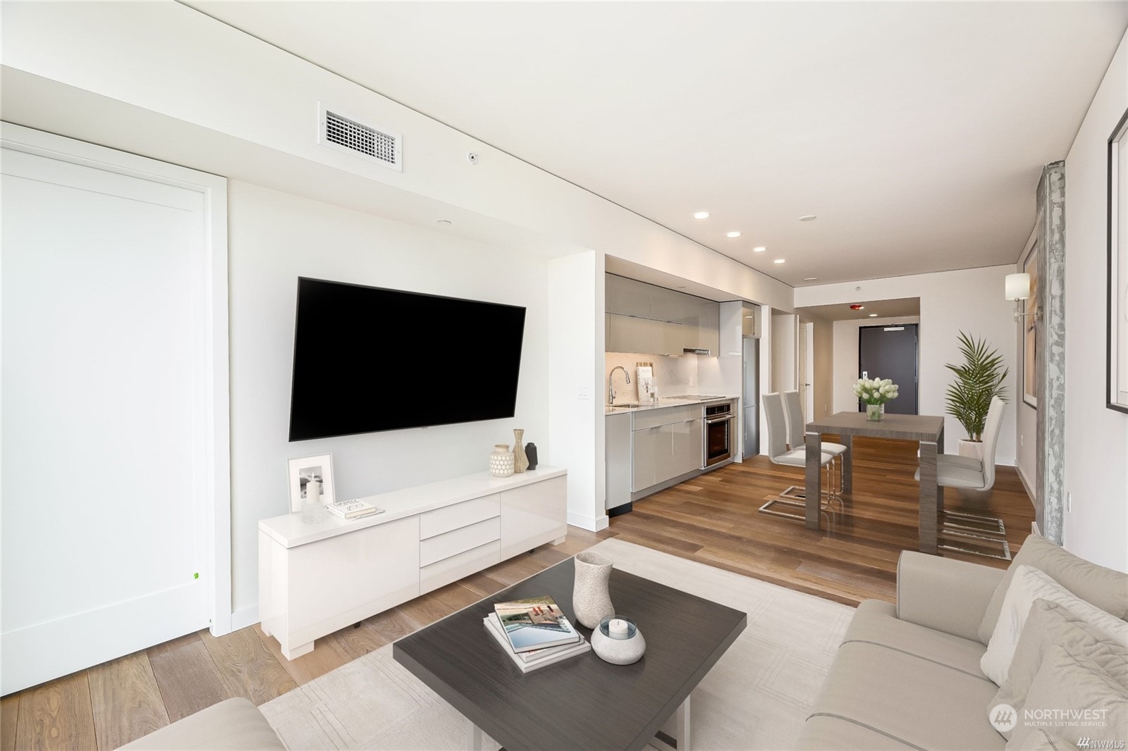 450 South Main Street, Unit 1110 Seattle, WA 98104 - Photo 3 of 24 a living room with furniture and a flat screen tv