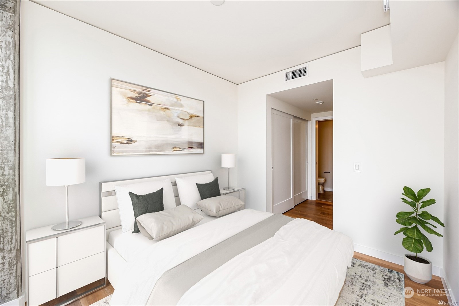 450 South Main Street, Unit 1110 Seattle, WA 98104 - Photo 5 of 24 a bedroom with a bed and a potted plant