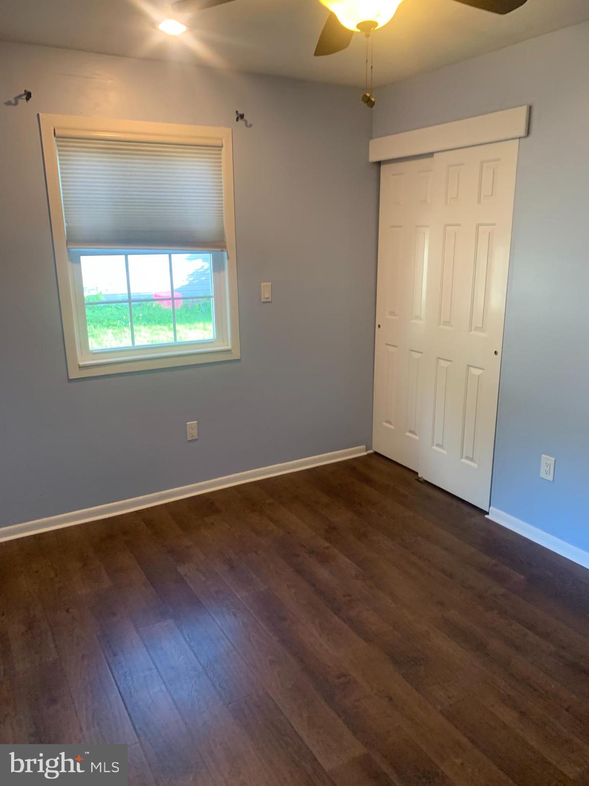 956 North Beecham Road Williamstown, NJ 08094 - Photo 12 of 17 an empty room with wooden floor and windows