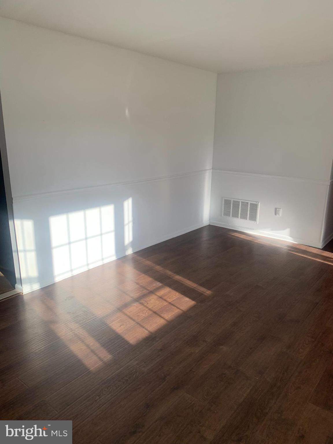 956 North Beecham Road Williamstown, NJ 08094 - Photo 6 of 17 an empty room with wooden floor and windows