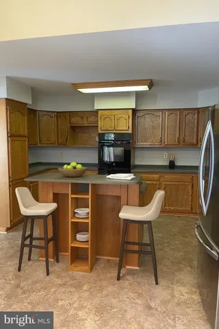 a kitchen with a table chairs and a refrigerator