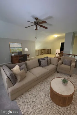 a view of a livingroom with a ceiling fan and window