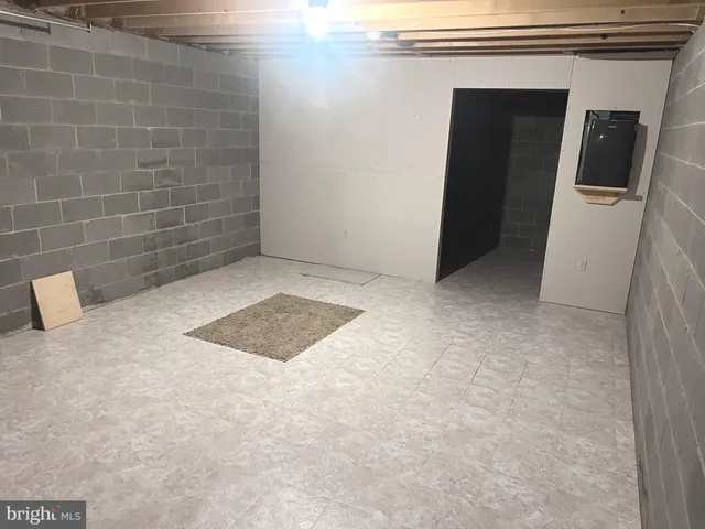 a room with gym equipment and a shower