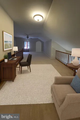 a living room with furniture and a lamp