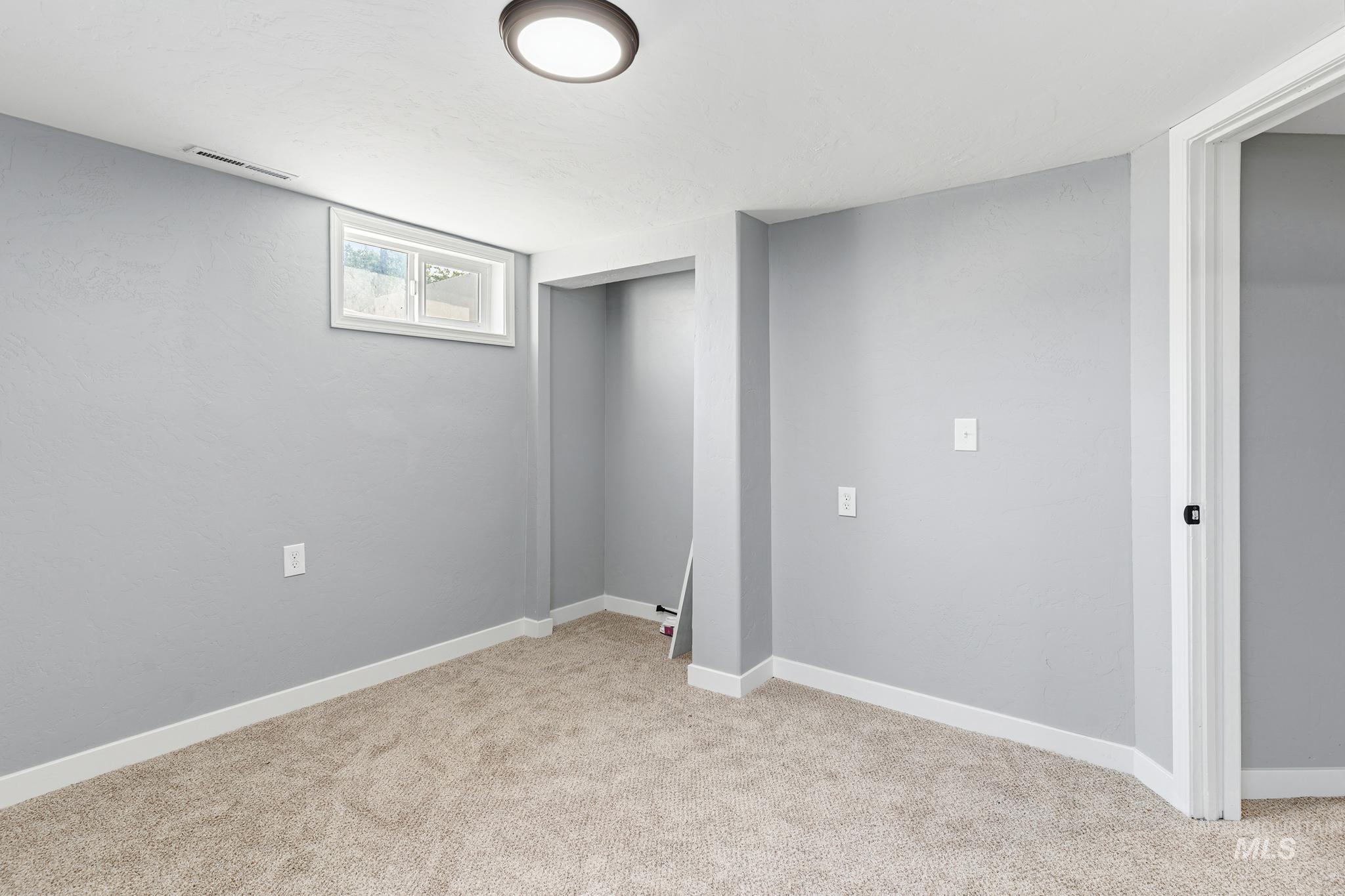 619 Thain Road Lewiston, ID 83501 - Photo 27 of 44 Carpeted room featuring light gray walls, white baseboards, and a white ceiling