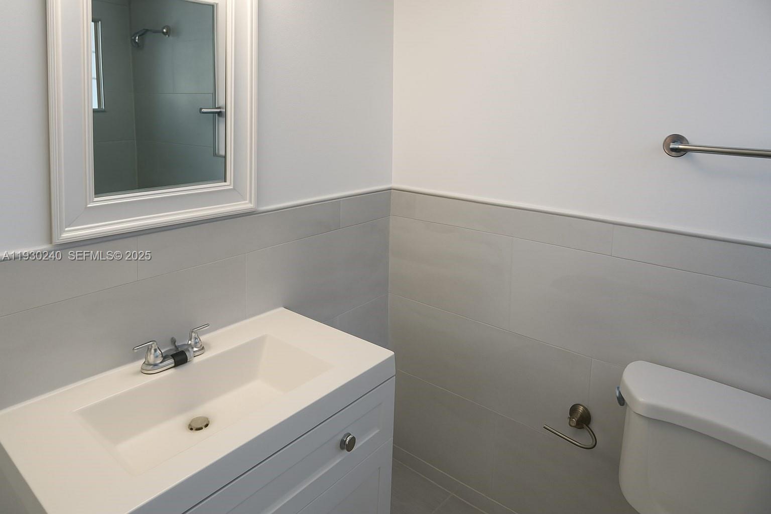 749 Southeast 15th Street, Unit 8 Fort Lauderdale, FL 33316 - Photo 11 of 15 a bathroom with a sink and mirror