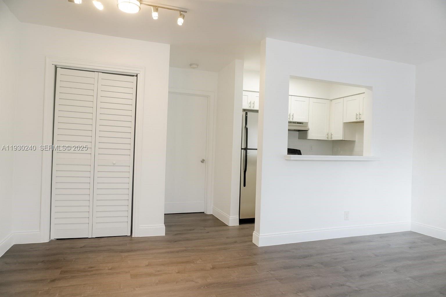 749 Southeast 15th Street, Unit 8 Fort Lauderdale, FL 33316 - Photo 2 of 15 an empty room with wooden floor and closet