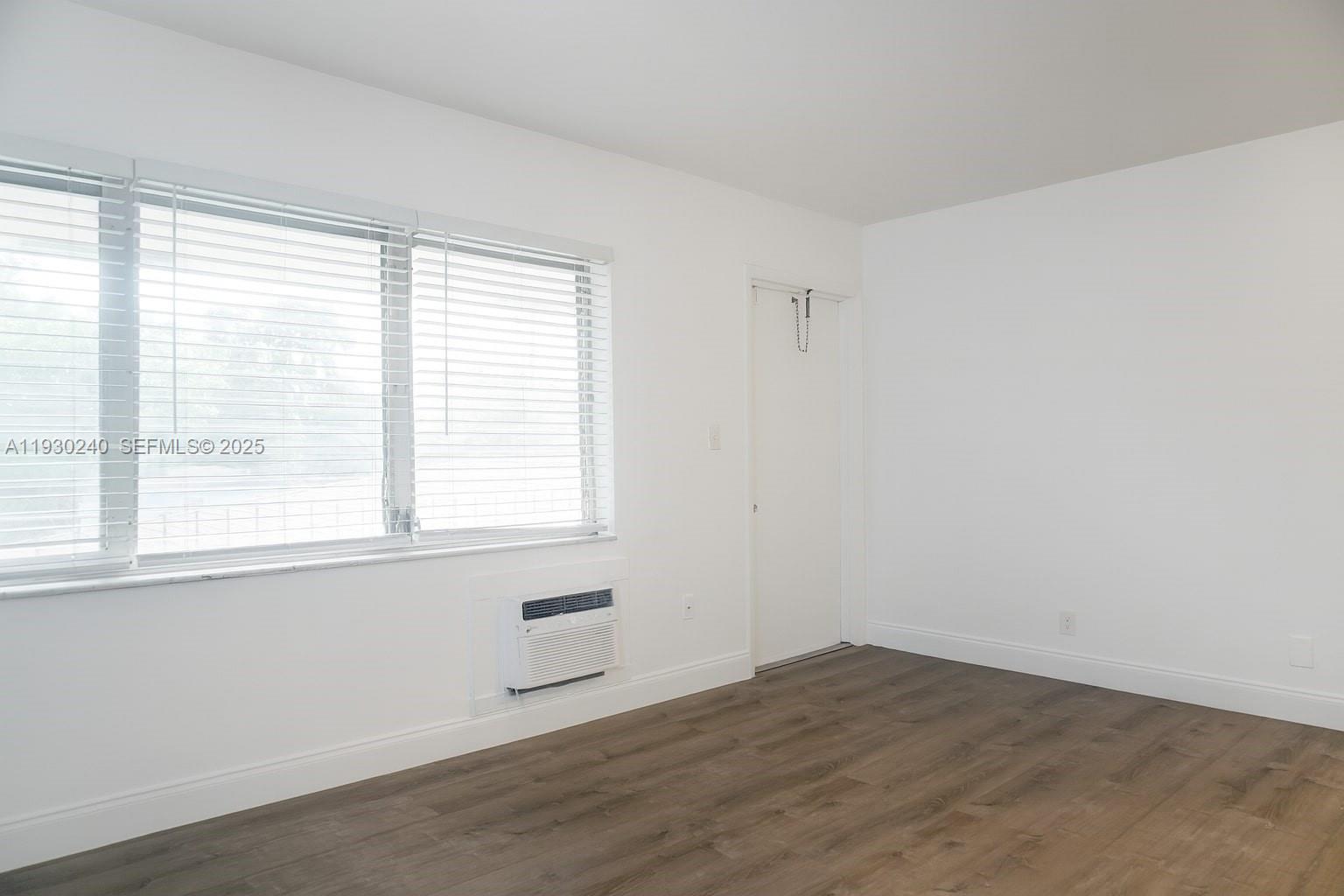 749 Southeast 15th Street, Unit 8 Fort Lauderdale, FL 33316 - Photo 6 of 15 a view of an empty room with wooden floor and a window