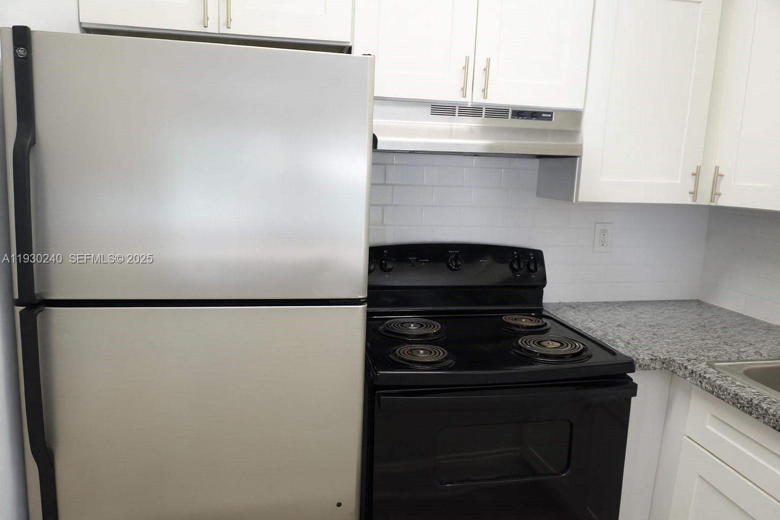 749 Southeast 15th Street, Unit 8 Fort Lauderdale, FL 33316 - Photo 7 of 15 a kitchen with refrigerator and a stove