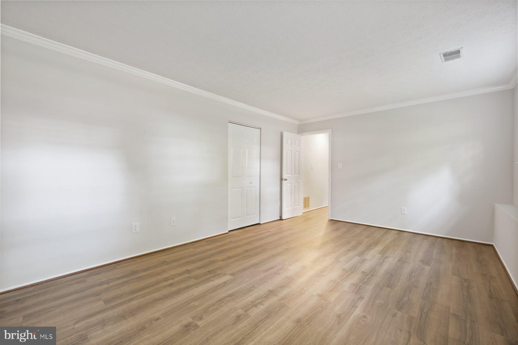 8304 Grainfield Road Severn, MD 21144 - Photo 20 of 49 a view of an empty room with wooden floor