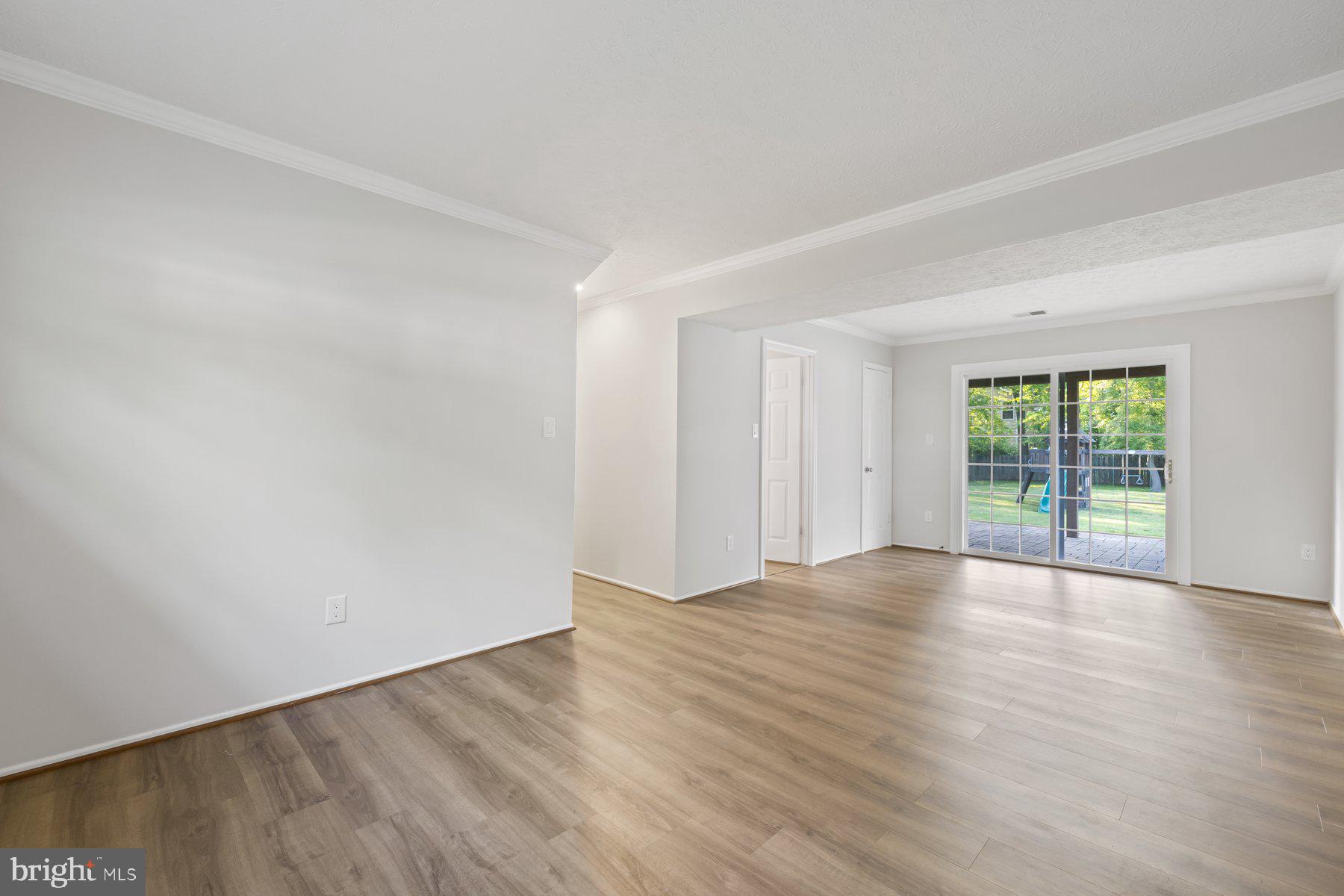 8304 Grainfield Road Severn, MD 21144 - Photo 24 of 49 a view of an empty room with wooden floor and a window