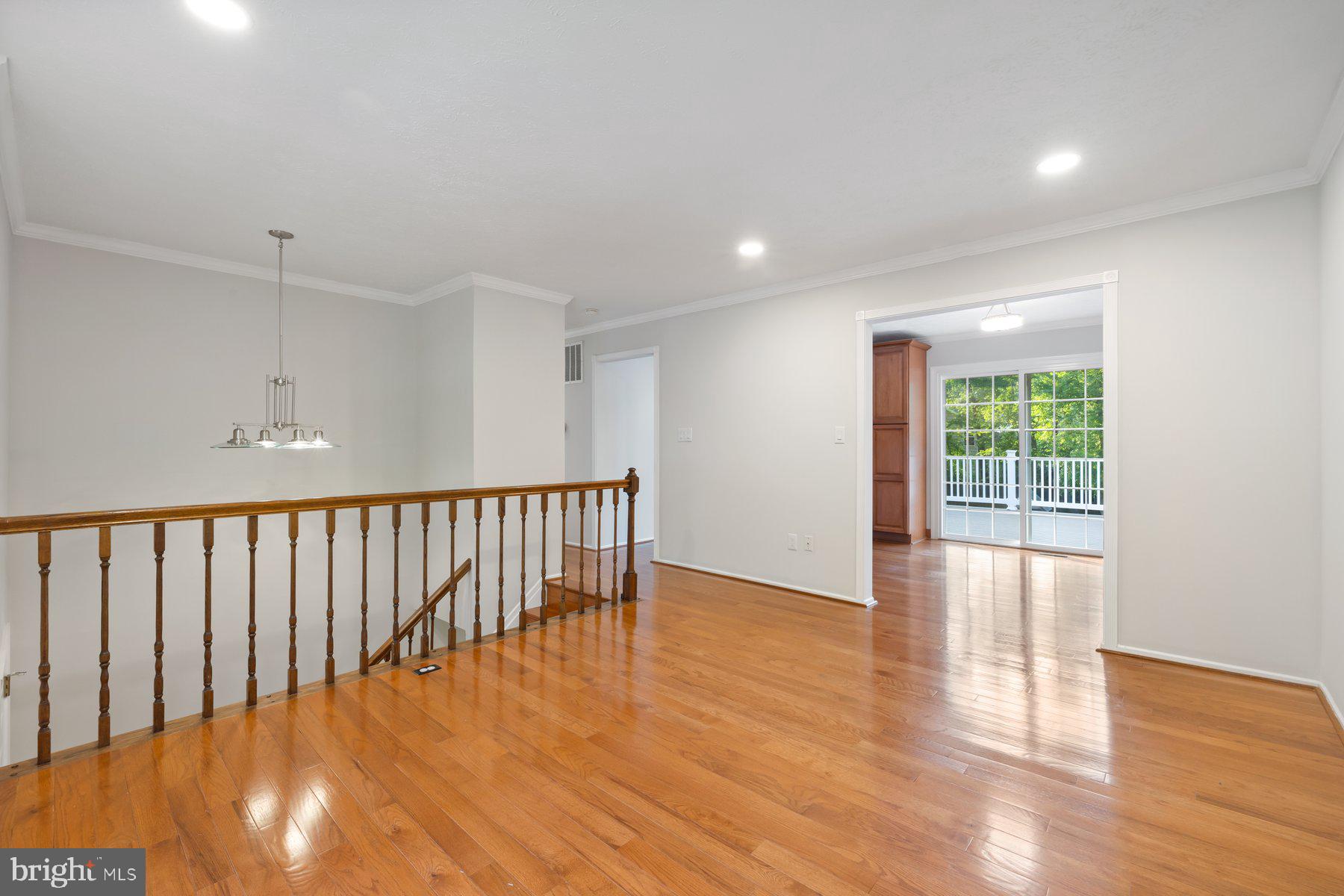 8304 Grainfield Road Severn, MD 21144 - Photo 8 of 49 a view of an empty room with wooden floor and a window
