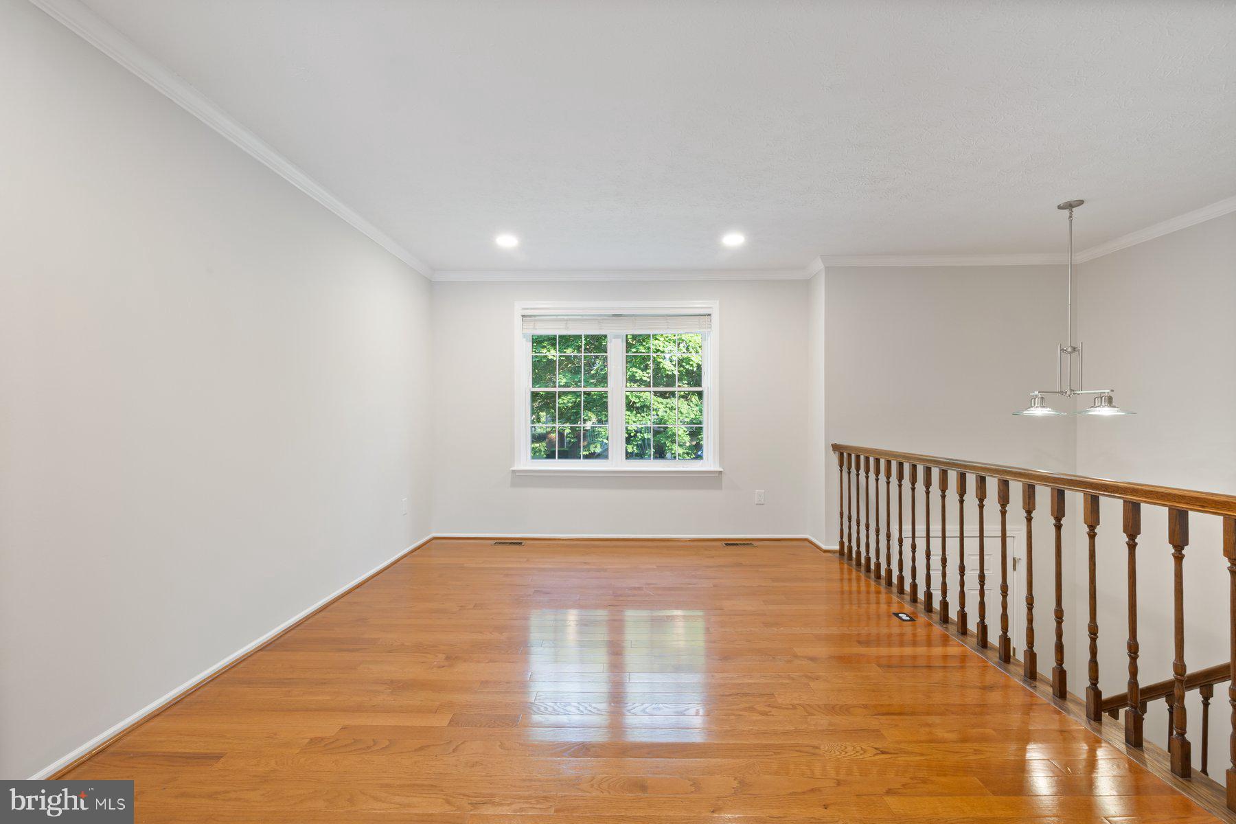 8304 Grainfield Road Severn, MD 21144 - Photo 9 of 49 a view of an empty room with wooden floor and a window
