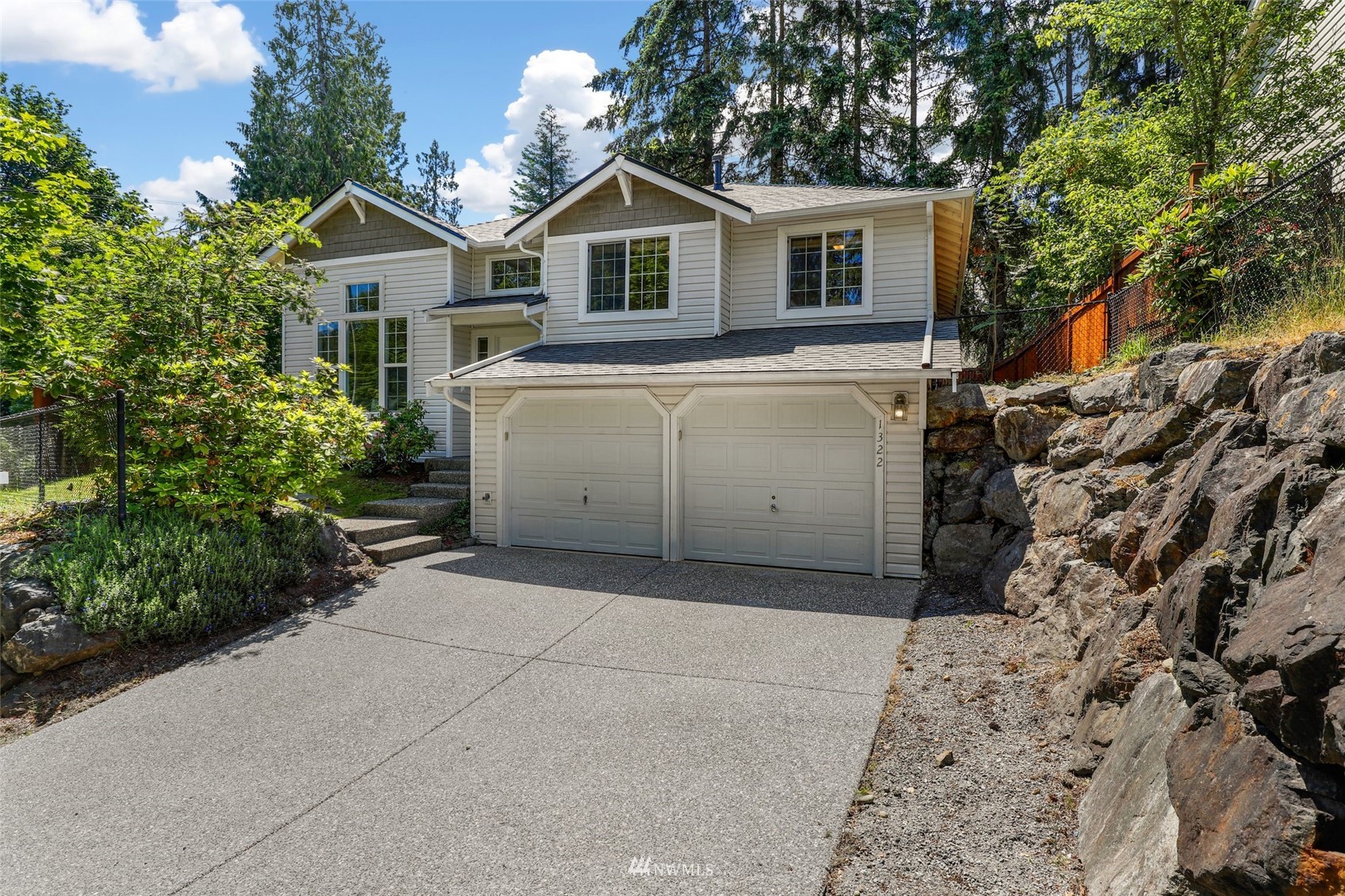 1322 196th Place Southeast Bothell, WA 98012 - Photo 1 of 40 a view of a house with a garage and a yard