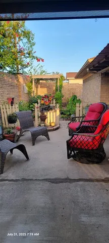 a view of a porch with furniture and a yard