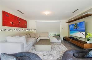 635 Curtiswood Drive Key Biscayne, FL 33149 - Photo 15 of 22 a living room with furniture and a flat screen tv