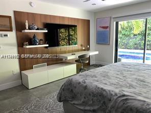 635 Curtiswood Drive Key Biscayne, FL 33149 - Photo 16 of 22 a living room with a bed and large window