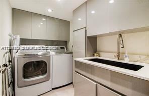 635 Curtiswood Drive Key Biscayne, FL 33149 - Photo 17 of 22 a kitchen with a sink a washer and dryer