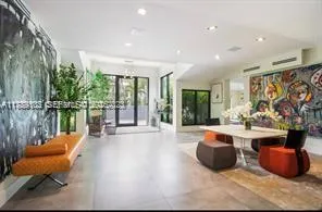 a living room filled with furniture and a large window