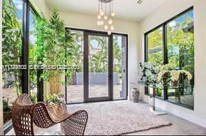 635 Curtiswood Drive Key Biscayne, FL 33149 - Photo 5 of 22 a living room with large windows and furniture