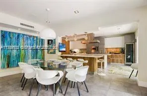 a dining room with furniture and a floor to ceiling window