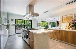 635 Curtiswood Drive Key Biscayne, FL 33149 - Photo 9 of 22 a kitchen with stainless steel appliances a sink stove and cabinets