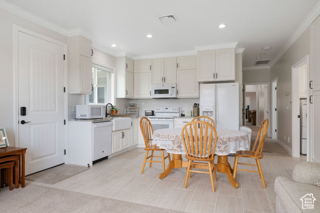 230 Boulder Way Leeds, UT 84746 - Photo 32 of 72 ADU Kitchen with ornamental molding, decorative tile backsplash, granite countertops, white appliances, recessed lighting, soft-close cabinetry and tile flooring.
