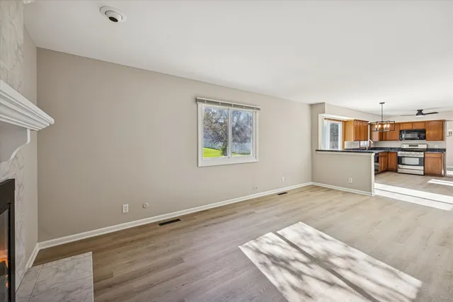 a view of a room with wooden floor and furniture