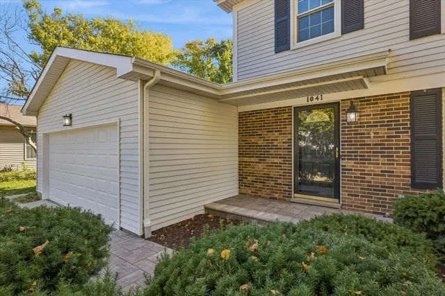 a view of a house with brick walls and a flower plants
