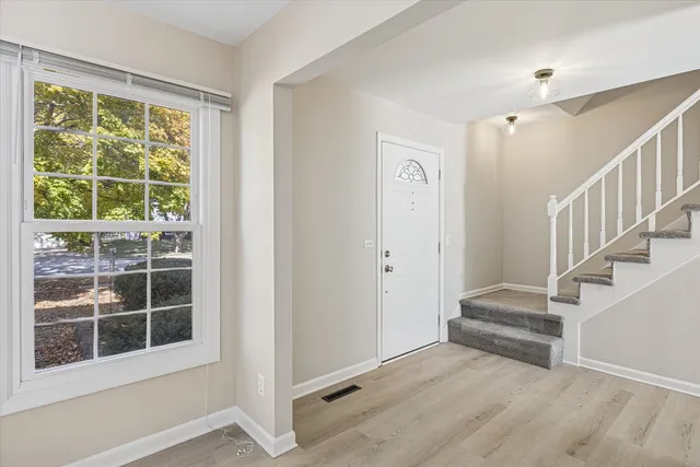 a view of staircase with white walls and windows
