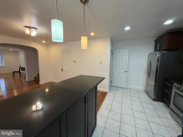 a kitchen with granite countertop a sink a counter top space appliances and cabinets