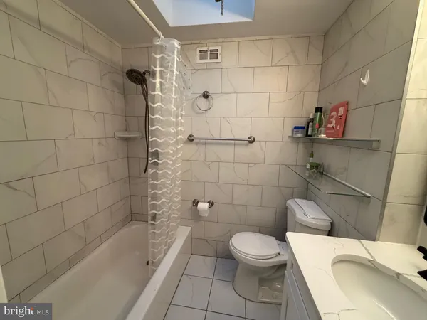 a bathroom with a toilet and bathtub